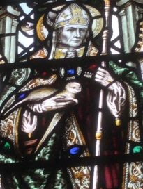 Detail of stained glass window depicting Saint Cuthbert holding an otter.