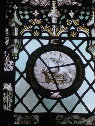 Detail of stained glass showing a historical warship under sail.